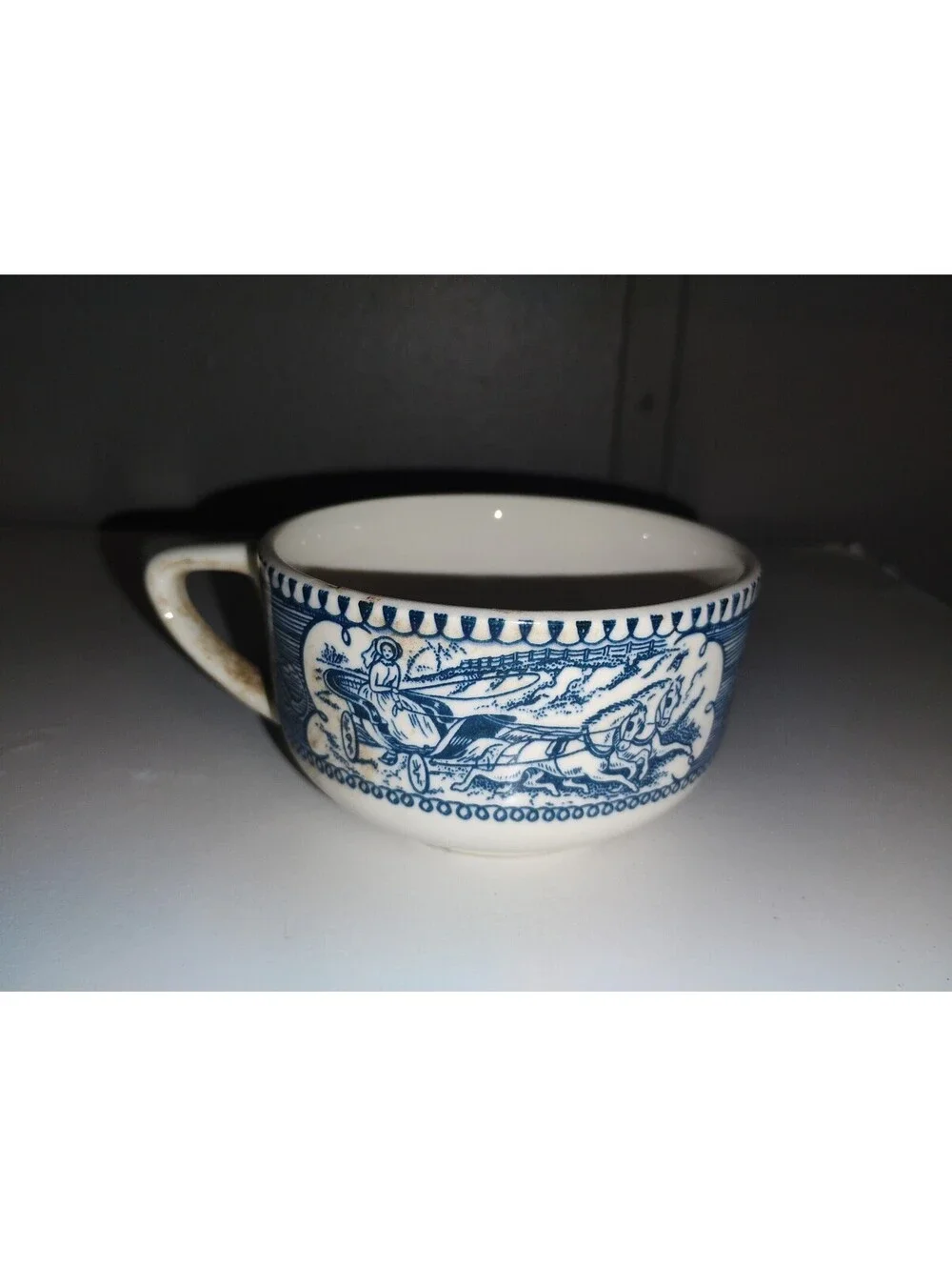 Vintage Blue and White Ceramic Cup with Horse and Carriage Design